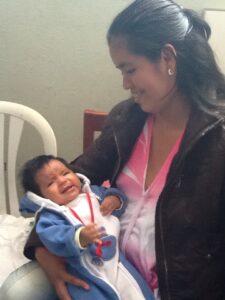 Peruvian girl with her baby